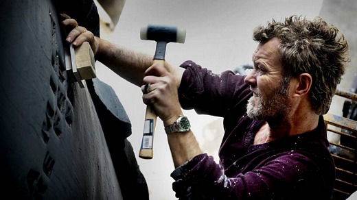 Magne at Tommerup Ceramic Workshop, hammering letters into one of the massive jars (Picture from Aftenposten)